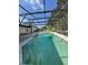 Refreshing pool with entry steps, surrounded by a screened enclosure and a view of the backyard at 2009 Nottingdale Ln, Winter Park, FL 32792