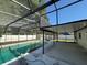 Pool and covered patio area surrounded by an enclosure, providing an ideal outdoor living space at 2009 Nottingdale Ln, Winter Park, FL 32792