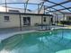 Pool and patio area with enclosure, perfect for swimming and outdoor enjoyment in a private setting at 2009 Nottingdale Ln, Winter Park, FL 32792