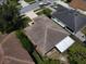 Aerial view of a house highlighting its roof, driveway, and surrounding greenery at 2028 Donegan Pl, Orlando, FL 32826