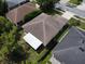 An aerial view of the house, showing the backyard, roof, landscaping, and backyard sun sail at 2028 Donegan Pl, Orlando, FL 32826