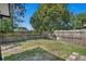 Fenced backyard featuring grass and a large shade tree at 2028 Donegan Pl, Orlando, FL 32826