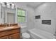 Bathroom featuring modern marble tile, updated vanity, and natural light at 2028 Donegan Pl, Orlando, FL 32826