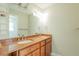Bathroom with double sink vanity with granite countertop, chrome hardware, and decorative lighting at 2028 Donegan Pl, Orlando, FL 32826