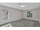 A bright bedroom with wood-look floors, two windows, fresh paint, and natural light at 2028 Donegan Pl, Orlando, FL 32826