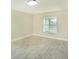 Neutral bedroom with new flooring, fresh paint, a large window, and baseboard trim at 2028 Donegan Pl, Orlando, FL 32826