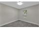A cozy bedroom with wood-look floors, fresh paint, and natural light through a single window at 2028 Donegan Pl, Orlando, FL 32826