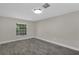 Cozy bedroom with wood-look floors, a modern ceiling light, and a sunny window at 2028 Donegan Pl, Orlando, FL 32826