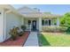 Inviting front porch with stylish landscaping featuring a covered entrance and fresh mulch at 2028 Donegan Pl, Orlando, FL 32826
