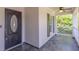 Covered front porch showcases tile flooring, an oval front door, and classic white railings at 2028 Donegan Pl, Orlando, FL 32826