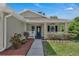 Inviting front porch with a tiled floor and decorative shrubs, perfect for relaxing outdoors at 2028 Donegan Pl, Orlando, FL 32826
