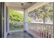 Spacious porch showcasing white railing, slate tile floors, and a calming outdoor view at 2028 Donegan Pl, Orlando, FL 32826