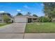 Charming single-story home with a well-maintained front yard and attached two-car garage at 2028 Donegan Pl, Orlando, FL 32826