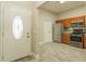 Entryway view leads into a kitchen with stainless steel appliances and wood grain tile flooring at 2028 Donegan Pl, Orlando, FL 32826