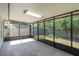 Enclosed lanai with gray tiled flooring at 2028 Donegan Pl, Orlando, FL 32826