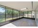 Enclosed lanai with gray tiled flooring and views of the yard at 2028 Donegan Pl, Orlando, FL 32826