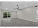 Spacious living area with sliding glass doors to a screened patio, ceiling fan, and wood-look tile flooring at 2028 Donegan Pl, Orlando, FL 32826