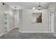 Bright living room featuring wood-look floors, pendant lighting, and an open view to the kitchen area at 2028 Donegan Pl, Orlando, FL 32826