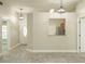 Open-concept living room featuring modern lighting, gray wood-look flooring, and a pass-through to the kitchen at 2028 Donegan Pl, Orlando, FL 32826