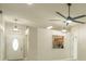Open-concept living room featuring modern lighting, a ceiling fan, and a pass-through to the kitchen at 2028 Donegan Pl, Orlando, FL 32826