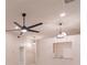 Modern living room showcases a ceiling fan, recessed lighting, and a peek-through to the kitchen at 2028 Donegan Pl, Orlando, FL 32826