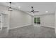 Bright living room with modern light fixtures, vaulted ceiling, and tile flooring at 2028 Donegan Pl, Orlando, FL 32826