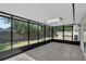 Enclosed patio with tile flooring overlooking the backyard at 2028 Donegan Pl, Orlando, FL 32826