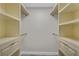 Walk-in closet featuring built-in shelving, drawers, and ample storage space at 2028 Donegan Pl, Orlando, FL 32826