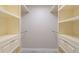 Walk-in closet featuring drawers, shelving, and metal hanging bars for ample storage at 2028 Donegan Pl, Orlando, FL 32826