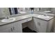 This bathroom includes dual sinks, granite countertops, and white cabinets at 204 E South St # 4056, Orlando, FL 32801