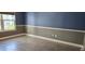 This bedroom features attractive herringbone floors, light-colored baseboards, and two-tone painted walls at 204 E South St # 4056, Orlando, FL 32801