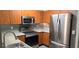 The kitchen features stainless steel appliances, wooden cabinets and gray countertops at 204 E South St # 4056, Orlando, FL 32801