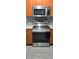 The kitchen features stainless steel appliances and wooden cabinets at 204 E South St # 4056, Orlando, FL 32801