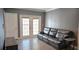 Inviting living room with doors to a private balcony, neutral walls, and wood-look tile at 204 E South St # 4056, Orlando, FL 32801