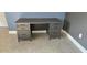 This office contains a black wooden desk with multiple drawers and handles on top of herringbone floors at 204 E South St # 4056, Orlando, FL 32801