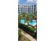 Beautiful community pool surrounded by lush landscaping and a multi-story residential building at 204 E South St # 4056, Orlando, FL 32801