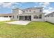 Exterior shot of the backyard featuring green grass, patio, and white fence at 2061 Rush Bay Way, Orlando, FL 32824