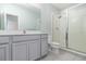 Well-lit bathroom featuring a single vanity, shower with glass doors and tiled flooring at 2061 Rush Bay Way, Orlando, FL 32824