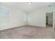 Bright bedroom featuring neutral carpeting, two windows, and light walls at 2061 Rush Bay Way, Orlando, FL 32824
