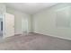 Neutral carpeted bedroom with a closet and large window bringing in natural light at 2061 Rush Bay Way, Orlando, FL 32824