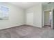 Neutral carpeted bedroom with double door closet and window bringing in natural light at 2061 Rush Bay Way, Orlando, FL 32824