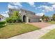 Beautiful home showcases a two-car garage, manicured lawn, and lovely curb appeal at 2061 Rush Bay Way, Orlando, FL 32824