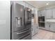 Close-up of stainless steel refrigerator and double ovens in modern kitchen at 2061 Rush Bay Way, Orlando, FL 32824