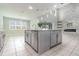 Open kitchen features a large island with pendant lighting and stylish countertops at 2061 Rush Bay Way, Orlando, FL 32824