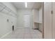 Functional laundry room featuring tile flooring, storage cabinets, and washer/dryer hookups at 2061 Rush Bay Way, Orlando, FL 32824