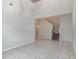 Open living room with high ceilings, tile floors, and access to the staircase at 2061 Rush Bay Way, Orlando, FL 32824