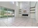 Spacious living room featuring a stone fireplace, built-in shelving, and sliding glass doors to lanai at 2061 Rush Bay Way, Orlando, FL 32824