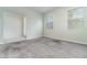Bright living room featuring carpet flooring and two sunny windows at 2061 Rush Bay Way, Orlando, FL 32824