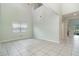 Bright living room featuring tile flooring, a window with blinds, and a soaring high ceiling at 2061 Rush Bay Way, Orlando, FL 32824