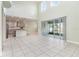 Open-concept living area with high ceilings, tile floors, and seamless access to kitchen and outdoor space at 2061 Rush Bay Way, Orlando, FL 32824